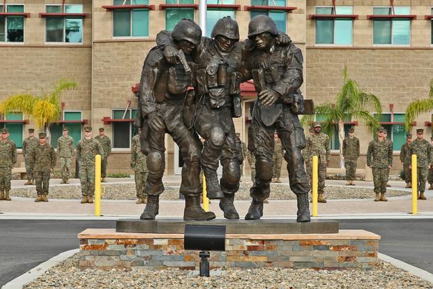 The Wounded Warrior Battalion-West held a ceremony Nov. 12, 2014, to unveil a monument honoring service members wounded during combat. The sculpture is based on the Operation Phantom Fury photograph "Hell House" of then 1st Sgt. Bradley Kasal being carried out of a house by two lance corporals after a fire fight where Kasal sustained injuries. "The monument is a symbol of camaraderie that's important to Marines, not only in combat but in the healing process as well, " said Robin Kelleher, president of Hope for the Warriors, which contributed to constructing the monument. (Shaltiel Dominguez/U.S. Marine Corps) The Wounded Warrior Battalion-West held a ceremony Nov. 12, 2014, to unveil a monument honoring service members wounded during combat. The sculpture is based on the Operation Phantom Fury photograph "Hell House" of then 1st Sgt. Bradley Kasal being carried out of a house by two lance corporals after a fire fight where Kasal sustained injuries. "The monument is a symbol of camaraderie that's important to Marines, not only in combat but in the healing process as well, " said Robin Kelleher, president of Hope